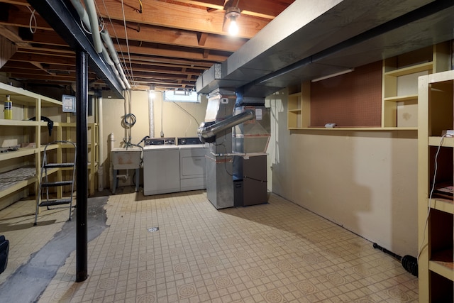 basement featuring separate washer and dryer, sink, and heating unit