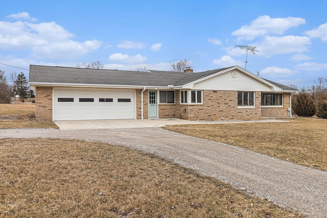 ranch-style home with a garage and a front lawn