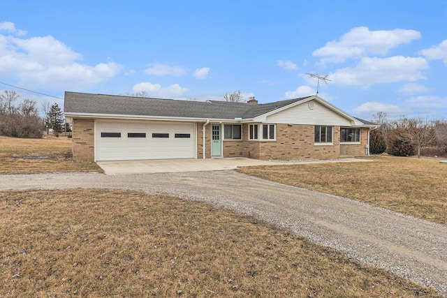 single story home featuring a garage and a front lawn