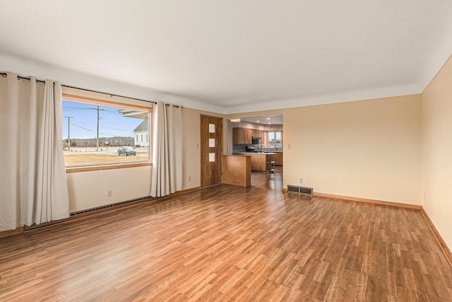 unfurnished living room with light hardwood / wood-style flooring