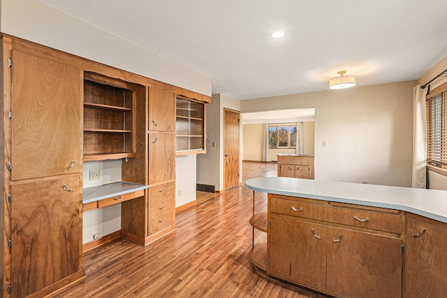 kitchen with dark wood-type flooring and built in desk