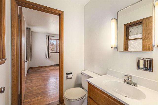 bathroom featuring vanity, hardwood / wood-style floors, and toilet