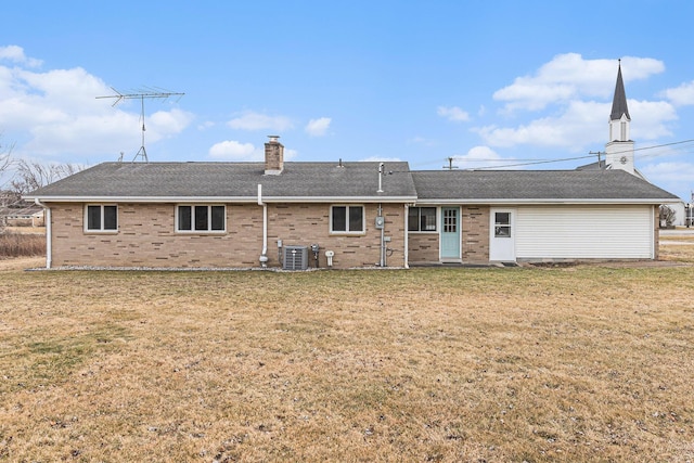 back of house with a yard and central air condition unit