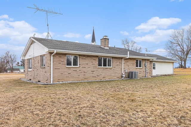 back of property featuring a lawn and central air condition unit