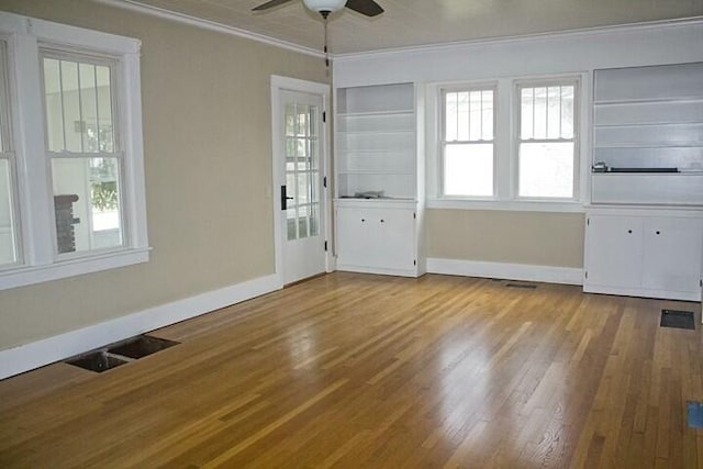 interior space with ornamental molding, plenty of natural light, and light hardwood / wood-style floors