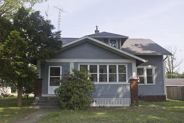 307 New York Ave, Dowagiac, MI 49047 - view of front of home with entry steps, a front yard, and roof with shingles