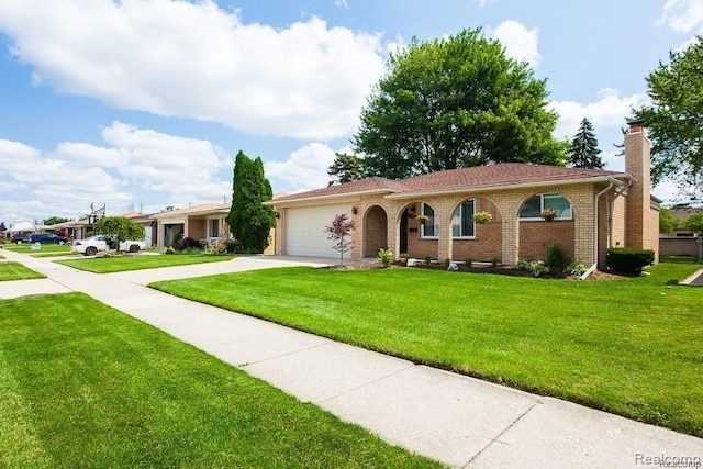 view of front of property featuring a garage and a front yard