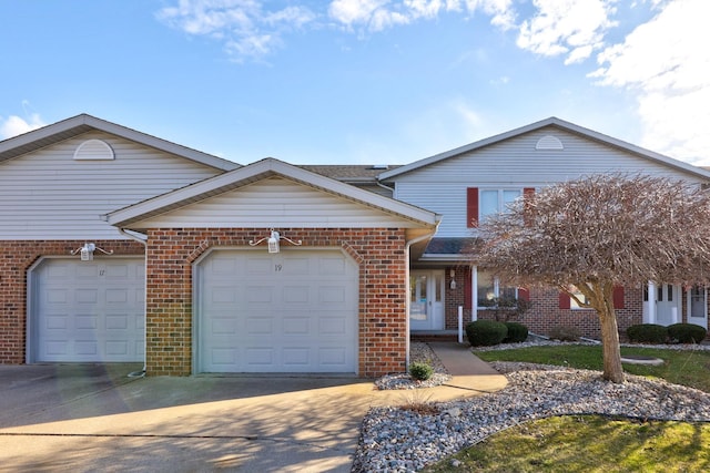 traditional home featuring an attached garage, brick siding, and driveway