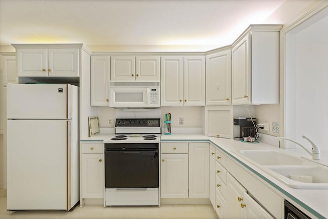 kitchen featuring white cabinetry, white appliances, light countertops, and a sink