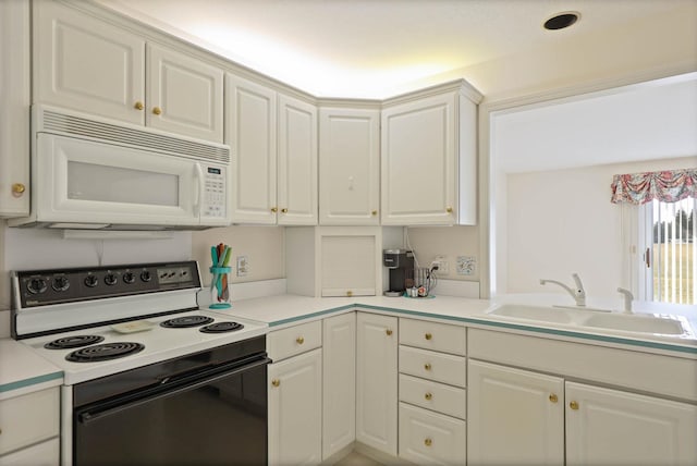 kitchen featuring light countertops, electric stove, white microwave, and a sink