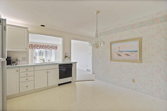 kitchen with wallpapered walls, light countertops, black dishwasher, and a sink