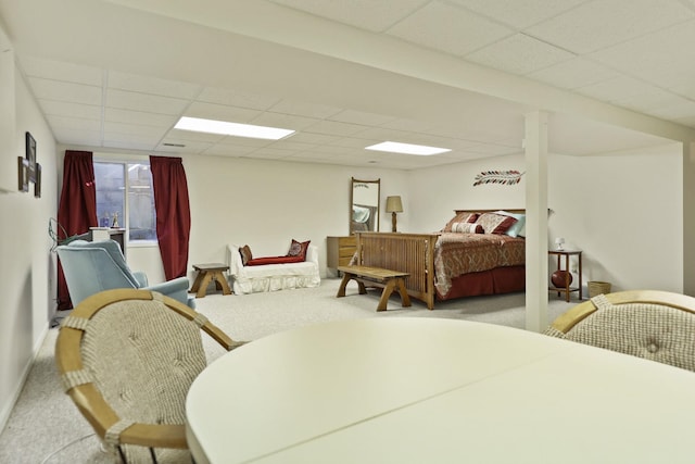 carpeted bedroom featuring a paneled ceiling