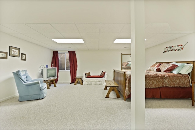 carpeted bedroom featuring baseboards and a paneled ceiling