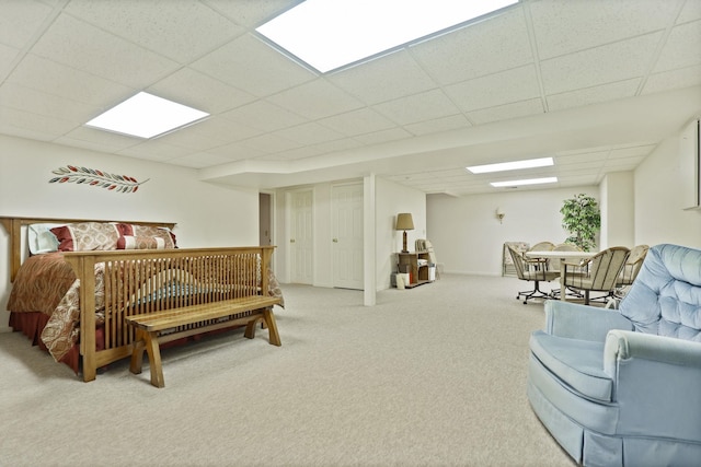 carpeted bedroom with a drop ceiling