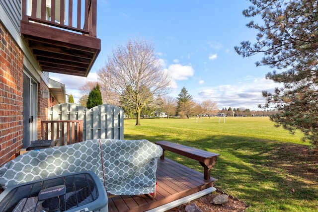 wooden deck featuring a yard and central AC unit