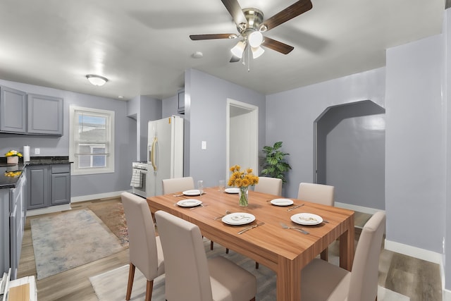 dining area featuring ceiling fan and light wood-type flooring