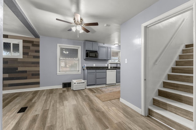 kitchen with gray cabinets, ceiling fan, white dishwasher, and light hardwood / wood-style floors