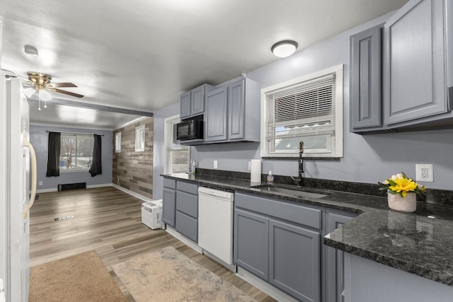 kitchen featuring white appliances, gray cabinets, sink, and light hardwood / wood-style flooring