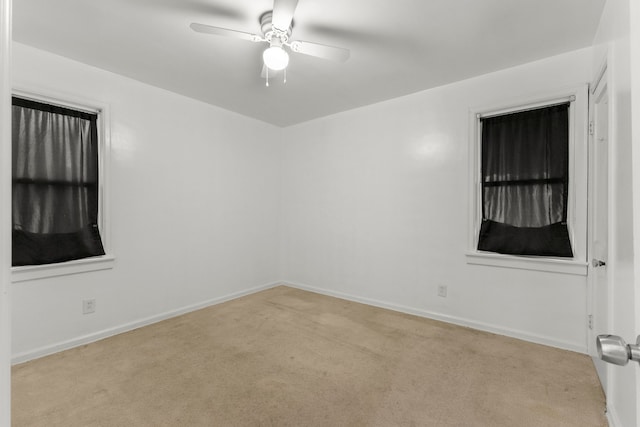 unfurnished room featuring light colored carpet and ceiling fan