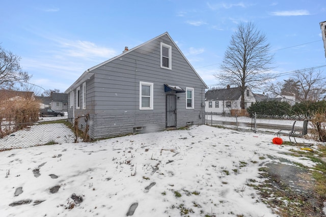 view of snow covered back of property