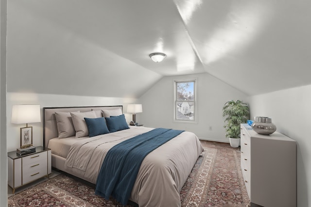 carpeted bedroom featuring vaulted ceiling