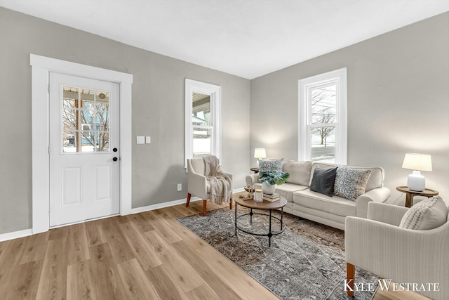 living room with a wealth of natural light and light wood-type flooring