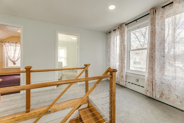 interior space featuring baseboard heating and carpet