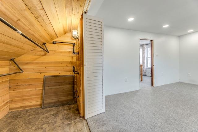 walk in closet with dark colored carpet, lofted ceiling, and baseboard heating