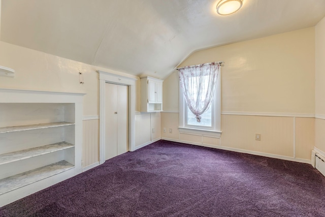 additional living space featuring lofted ceiling, carpet, and built in shelves