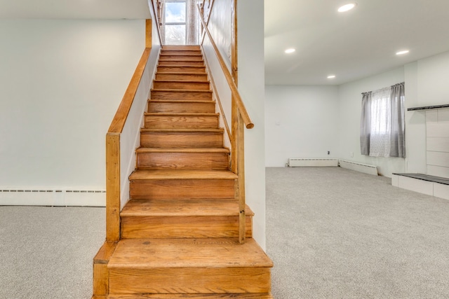 staircase with a baseboard radiator and carpet