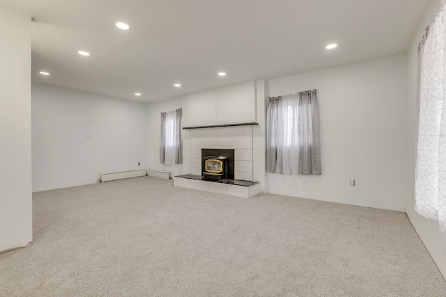 unfurnished living room featuring carpet floors and a baseboard radiator