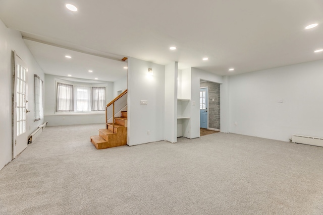 basement featuring a baseboard heating unit and light carpet