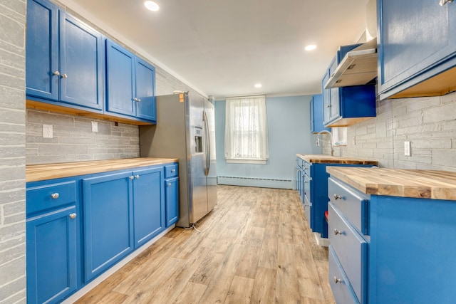 kitchen with butcher block countertops, blue cabinets, a baseboard radiator, backsplash, and light wood-type flooring