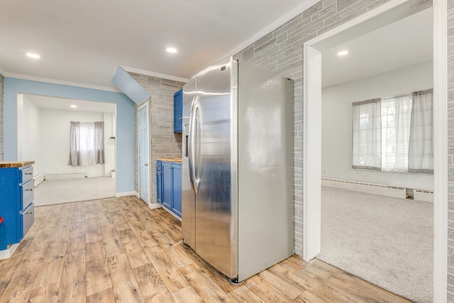 kitchen featuring blue cabinets, stainless steel refrigerator with ice dispenser, and light wood-type flooring