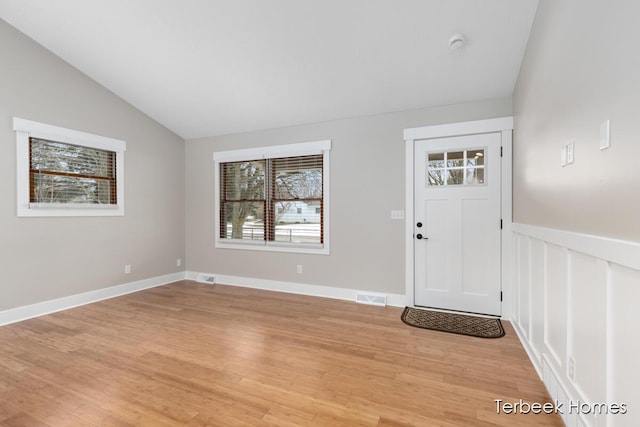 entryway featuring wood-type flooring and vaulted ceiling