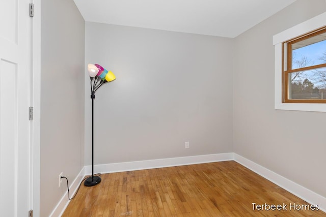 unfurnished room with hardwood / wood-style flooring