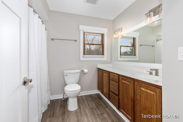 bathroom with vanity, toilet, and hardwood / wood-style floors