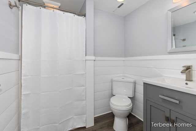 bathroom featuring vanity, wood-type flooring, and toilet