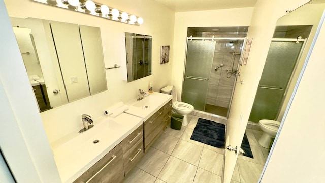 bathroom with vanity, a shower with shower door, and toilet