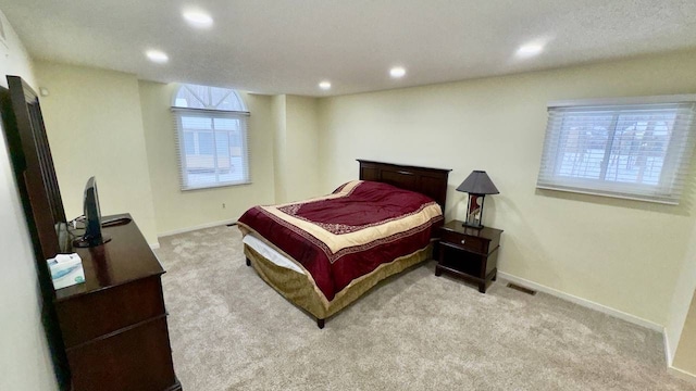 bedroom featuring light colored carpet