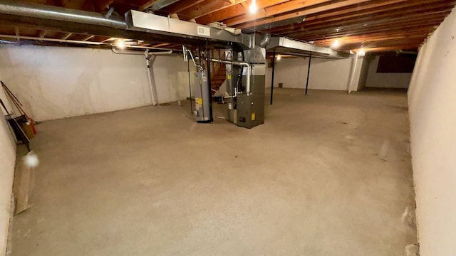 basement with gas water heater and heating unit