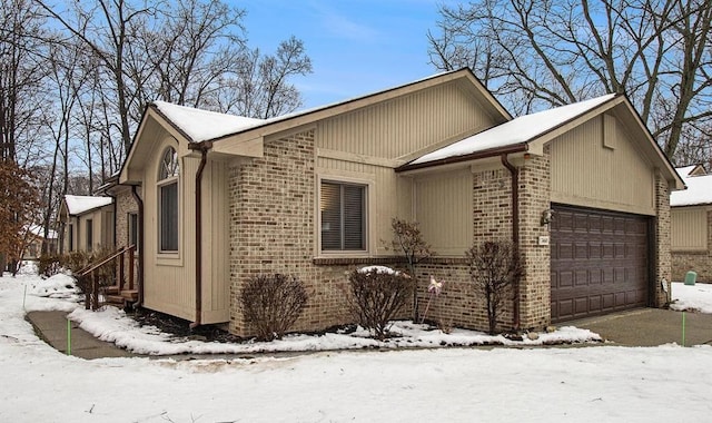 view of snow covered exterior with a garage