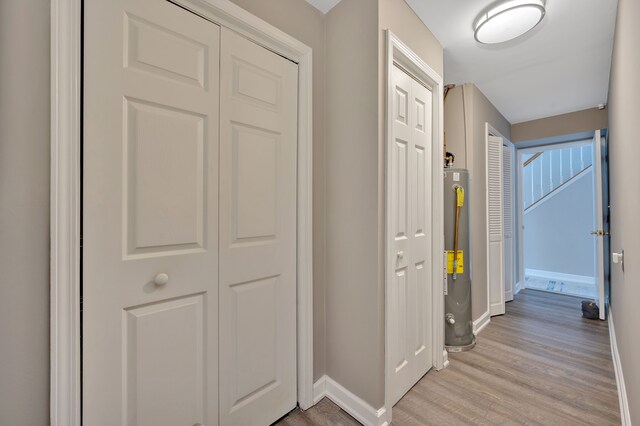 1611 Harwood Dr, Oxford, MI 48371 - corridor with light wood finished floors and water heater