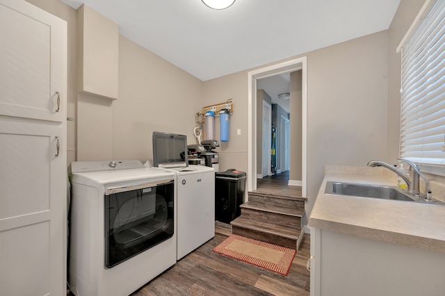 1611 Harwood Dr, Oxford, MI 48371 - laundry room featuring washer and dryer, wood finished floors, cabinet space, and healthy amount of natural light