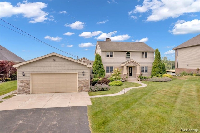 1611 Harwood Dr, Oxford, MI 48371 - view of front facade featuring a front yard, a chimney, stone siding, and a detached garage