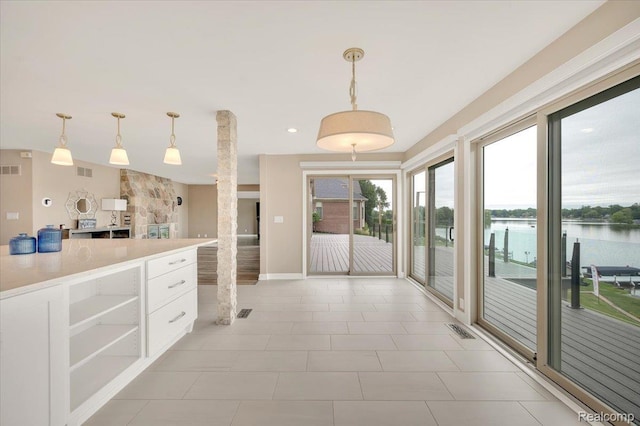 1611 Harwood Dr, Oxford, MI 48371 - kitchen featuring white cabinets, light countertops, a water view, open shelves, and pendant lighting