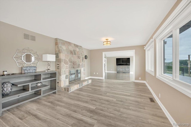 1611 Harwood Dr, Oxford, MI 48371 - unfurnished living room with wood finished floors and a stone fireplace