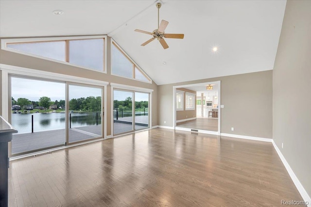 1611 Harwood Dr, Oxford, MI 48371 - unfurnished living room featuring high vaulted ceiling, a ceiling fan, wood finished floors, and a water view