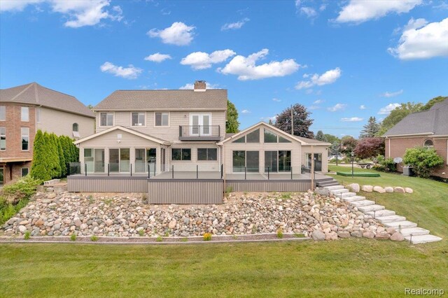 1611 Harwood Dr, Oxford, MI 48371 - rear view of house with a sunroom, a chimney, a balcony, and a lawn