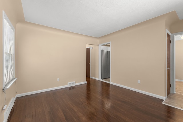 unfurnished bedroom with dark hardwood / wood-style floors